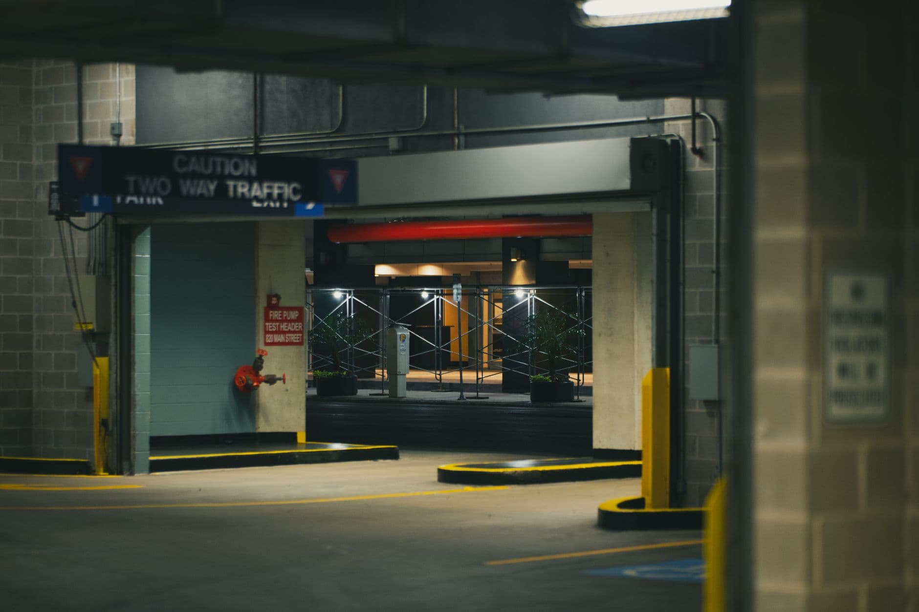 Explore the moody ambiance of a Houston parking garage at night with industrial architecture and dim lighting.